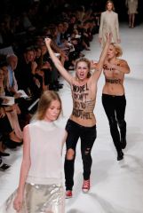 Activists Of The feminist movement FEMEN protest On The catwalk As models present creations For Nina